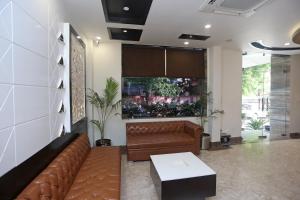 a living room with a couch and a table at Collection O Hotel Pearl Blue in Tājganj