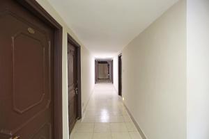 an empty hallway with a door and a hallwayngth at Flagship Hotel Gurukripa in Raipur