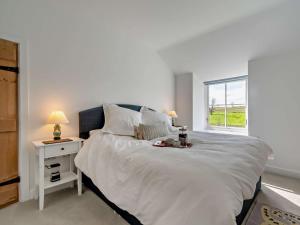 a bedroom with a large white bed with a window at 3 Bed in Malton 94171 