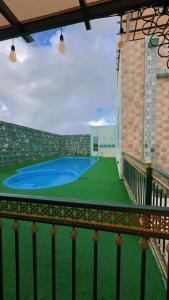 a view of a pool from a balcony at Bait Alsalam in Sayq