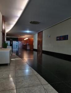 a large room with a lobby with a table at Flat em frente à Praia in Vitória