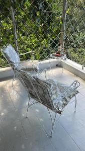 a metal chair sitting on a patio with a tub at Adella's Blue Mountain Coffee Farmstay in Kingston