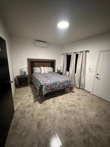 a bedroom with a bed in a room at Sunrise Apartments in Rosarito
