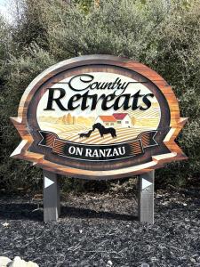 a sign for a county retreats on ramsonia at Country Retreats on Ranzau 8 in Hope
