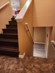 een trap in een huis met een trap bij Beautiful updated home centrally located, close to General Hospital in Regina