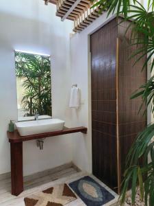 a bathroom with a sink and a mirror at Ant Homes by Afrind Hospitality in Cochin