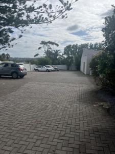 a parking lot with two cars parked in it at Luxury Suites on Santorini in East London