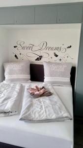 a bed with a sign that says sweet dreams on it at Sweet Dreams Wellness Appartement in Seefeld in Tirol