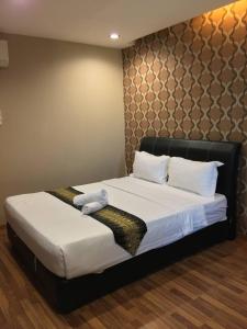 Ein Bett oder Betten in einem Zimmer der Unterkunft M BOUTIQUE INN (BINTANG JAYA)
