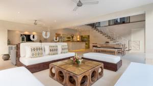 a living room with a white couch and a table at Casa Mateo Villa in Seminyak