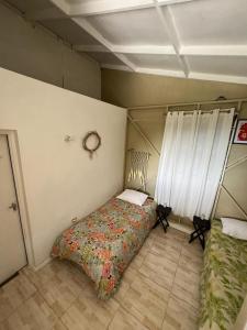 a bedroom with a bed in the corner of a room at Adella's Blue Mountain Coffee Farmstay in Kingston