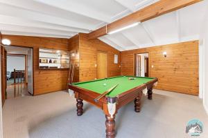 a pool table in a room with wooden walls at Aircabin - KANGY ANGY - Rural Retreat - 8 Beds House in Tuggerah