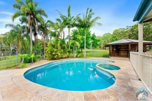 a swimming pool in the yard of a house at Aircabin - KANGY ANGY - Rural Retreat - 8 Beds House in Tuggerah