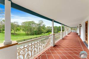 an empty balcony with a view of a green field at Aircabin - KANGY ANGY - Rural Retreat - 8 Beds House in Tuggerah