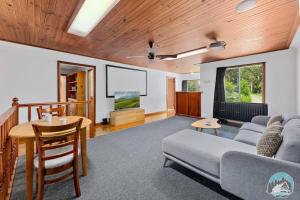 a living room with a couch and a table at Aircabin - KANGY ANGY - Rural Retreat - 8 Beds House in Tuggerah