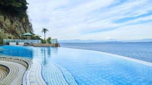 a swimming pool with a view of the ocean at Enoshima Hotel ーEnoshima Island Spa Hotel Buildingー in Fujisawa