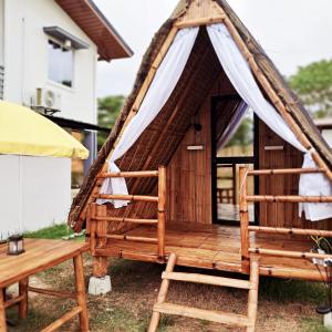 a gazebo with a chair and a table at The Beaulah Overlooking Cozy Hideaway in Hundred Islands in Alaminos