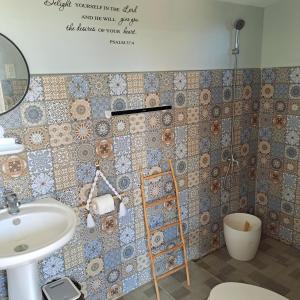 a bathroom with a sink and a mirror at The Beaulah Overlooking Cozy Hideaway in Hundred Islands in Alaminos