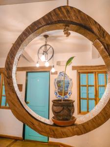 un espejo en una habitación con una maceta en La Rosa Nautica Hostel, en Guaduas