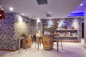 een bar met krukken en een stenen muur bij Macchi Hotel - Taipei in Taipei
