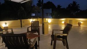 a patio with chairs and a table and lights at La Shashalia Luxury in Puducherry