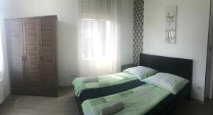 Posteľ alebo postele v izbe v ubytovaní West Residence