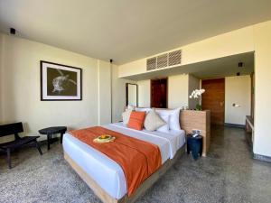 a bedroom with a large bed and a desk at MAUA Nusa Penida Bali in Nusa Penida