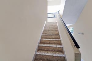 a staircase in a house with a stair case at Collection O Senthamizh Residency in Chennai