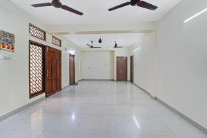 an empty hallway of a house with ceiling fans at Collection O Senthamizh Residency in Chennai