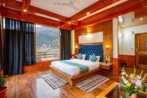 - une chambre avec un lit et une grande fenêtre dans l'établissement FabHotel La Kailasha Regency, à Manali