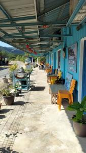 a row of tables and chairs sitting outside of a building at Marina's Redang Boat in Redang Island