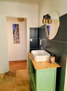 a bathroom with a sink and a mirror at Maison Pays Basque 12 pers piscine in Saint-Esteben +30 photos