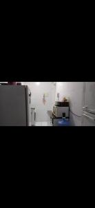 a kitchen with a refrigerator and a microwave at Quarto privado somente para mulheres e banheiro exclusivos - demais areas compartilhadas in Maceió