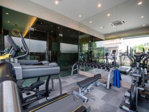 a gym with treadmills and machines in a building at Patong Bay Residence in Patong Beach
