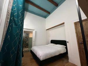 a bedroom with a bed with a blue ceiling at Carafa's Central Apartment by HHN in Naples