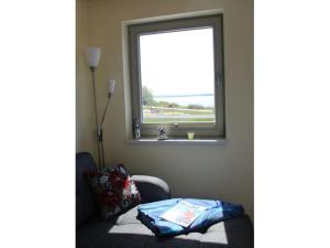 a living room with a chair and a window at Chudzik Modern retreat in Rerik