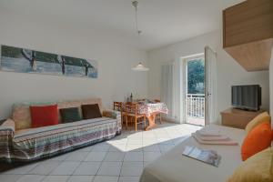 a living room with a couch and a table at Casa al Cor Apartments - Happy Rentals in Nago-Torbole