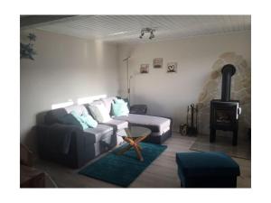 a living room with a couch and a stove at Bungalow at Galgenberg in Wernigerode in Wernigerode
