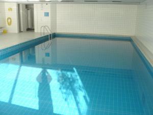 a man is standing in a swimming pool at Forest Residence Modern retreat in Unterkirnach