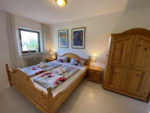 a bedroom with a large wooden bed with candles on it at 7 Bergschlössl Modern retreat in Oberaudorf