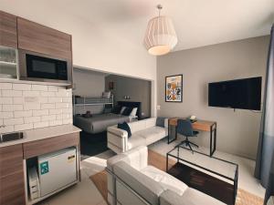 a living room with a couch and a tv at Altair Motel in Cooma