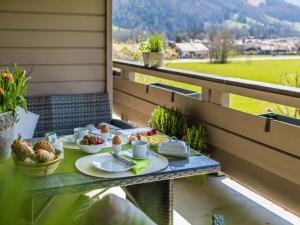 a tray of food on a table on a balcony at Hörndlwand Ruhpolding in Ruhpolding