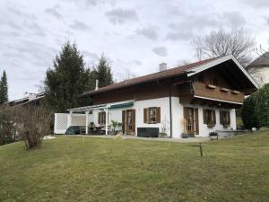 a small white house with a grass yard at Chalet Salzeder Modern retreat in Bayerisch Gmain