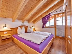 a bedroom with a large bed in a room with wooden ceilings at Holiday apartment Zugspitze in Krün