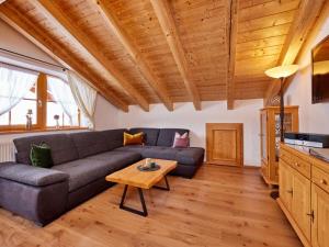 a living room with a couch and a table at Holiday apartment Zugspitze in Krün