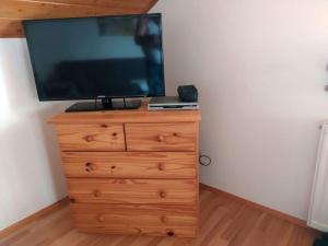 a television on top of a wooden dresser at Schober Modern retreat 