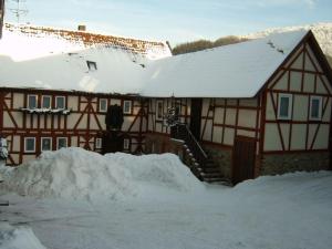 a snow covered house with a snow covered roof at Old Mill Fam Menz 