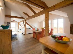 a kitchen and living room with wooden beams at Platzl in the sacristan's house in Lenggries