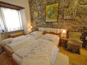 um quarto com 2 camas e uma parede de pedra em Rust pile Modern retreat em Constança