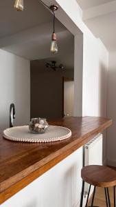 a mirror on a counter in a kitchen with a table at City Centre Apartment by Noire Property in Manchester